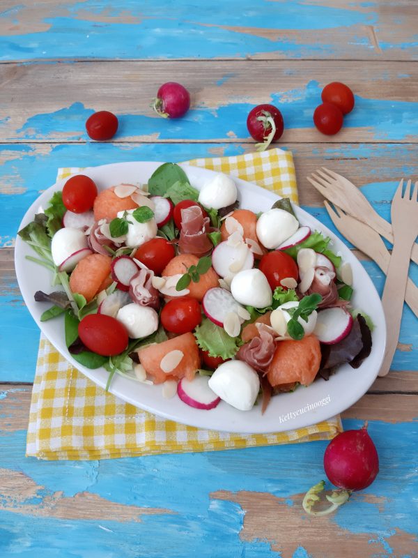 Serviamo <i><b>Insalata misticanza con melone</b></i>  condita con la vinaigrette e foglioline di origano fresco.